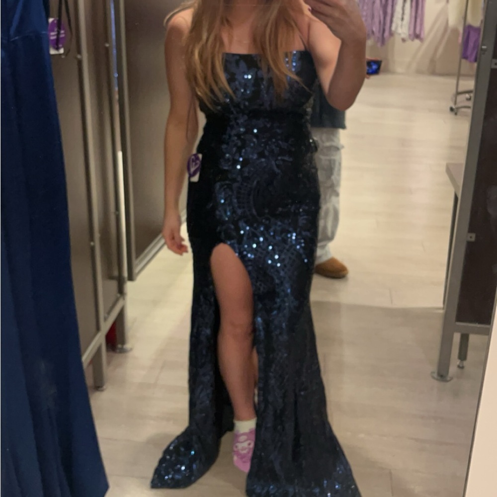 navy blue sparkly prom dress. It’s floor length with a a back cross strap.